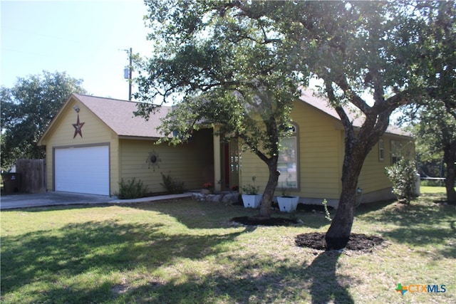 view of front of home with a front yard and a garage