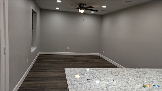 unfurnished room featuring dark hardwood / wood-style flooring and ceiling fan