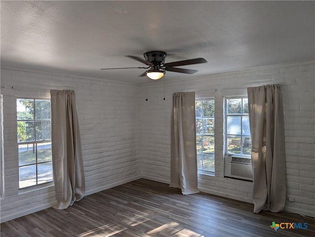 1201 Oblate Dr, Canyon Lake, TX 78133 - spare room with a ceiling fan, wood finished floors, brick wall, and baseboards