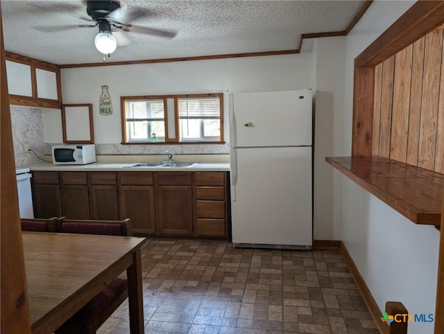 1201 Oblate Dr, Canyon Lake, TX 78133 - kitchen with white appliances, ceiling fan, brick patterned flooring, a sink, and tasteful backsplash