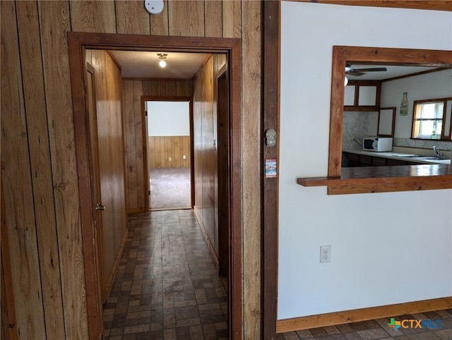 1201 Oblate Dr, Canyon Lake, TX 78133 - hall with a sink, wood walls, and baseboards