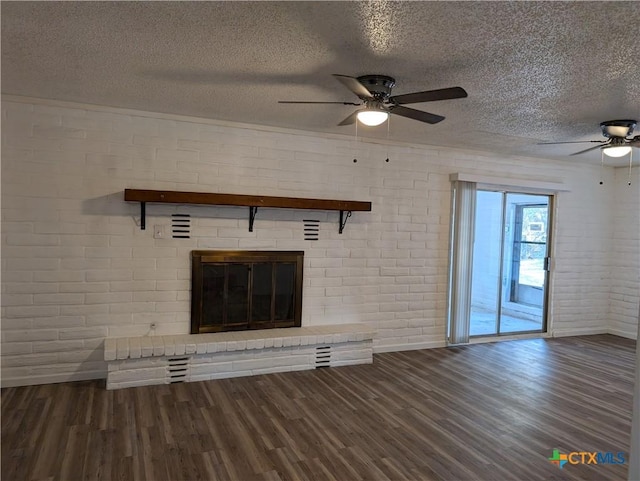 1201 Oblate Dr, Canyon Lake, TX 78133 - unfurnished living room featuring a ceiling fan, baseboards, a textured ceiling, a brick fireplace, and brick wall