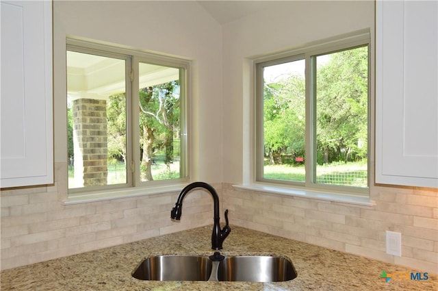 850 County Road 3152, Kempner, TX 76539 - kitchen with decorative backsplash, white cabinets, and light stone counters