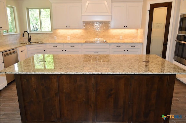 850 County Road 3152, Kempner, TX 76539 - kitchen with custom exhaust hood, stainless steel appliances, white cabinetry, and decorative backsplash