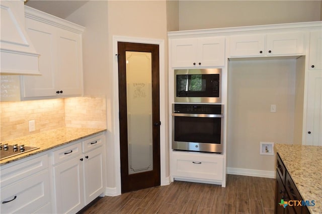 850 County Road 3152, Kempner, TX 76539 - kitchen featuring appliances with stainless steel finishes, decorative backsplash, white cabinetry, and wood tiled floors