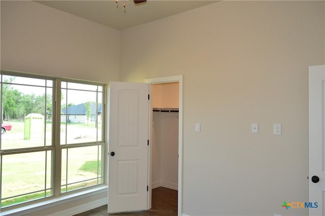 850 County Road 3152, Kempner, TX 76539 - unfurnished bedroom featuring multiple windows, dark wood-style floors, a spacious closet, and a closet