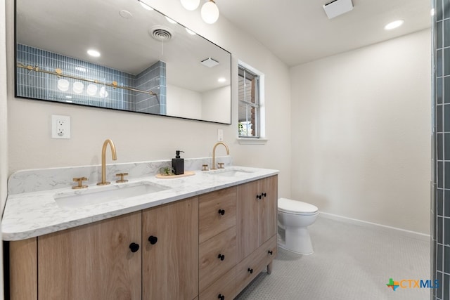 bathroom with vanity, tile patterned floors, and toilet