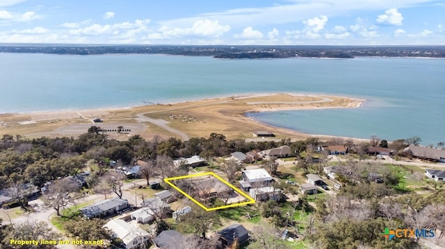 drone / aerial view featuring a view of the beach and a water view