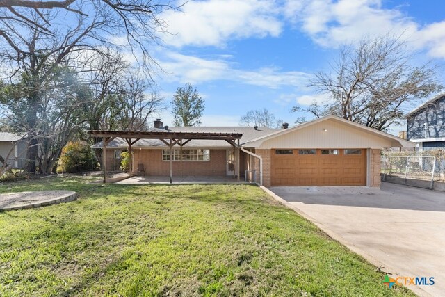 ranch-style home featuring a garage, a pergola, and a front yard