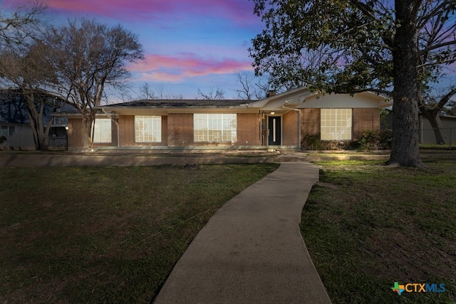 ranch-style house featuring a yard