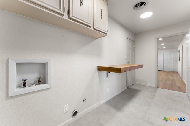 clothes washing area featuring cabinets, electric dryer hookup, and hookup for a washing machine