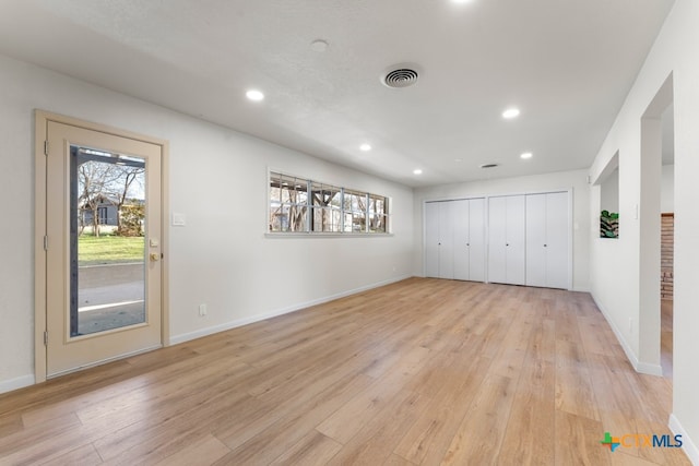 unfurnished bedroom featuring a closet and light wood-type flooring