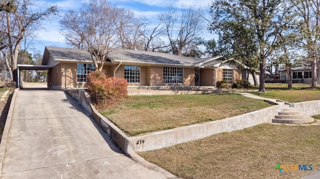 single story home featuring a carport and a front yard