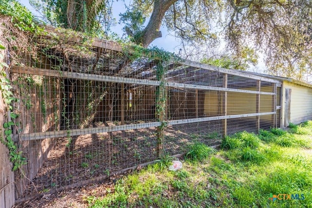 view of side of home featuring an outdoor structure