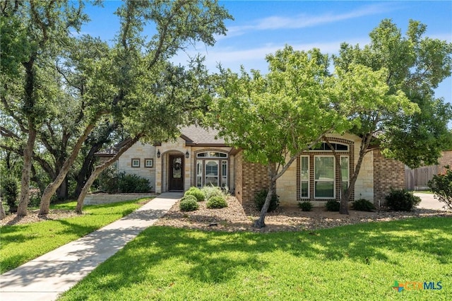 6319 Drexel Loop, Temple, TX 76502 - view of front facade featuring stone siding, a front yard, and brick siding