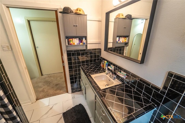 bathroom with vanity and tile walls