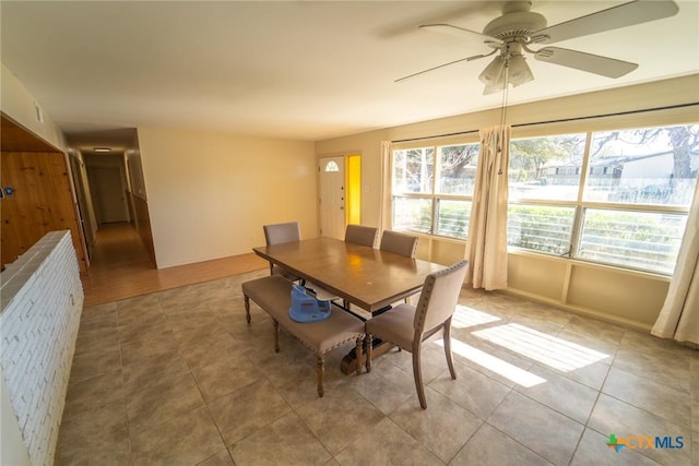 dining area featuring ceiling fan and light tile patterned floors