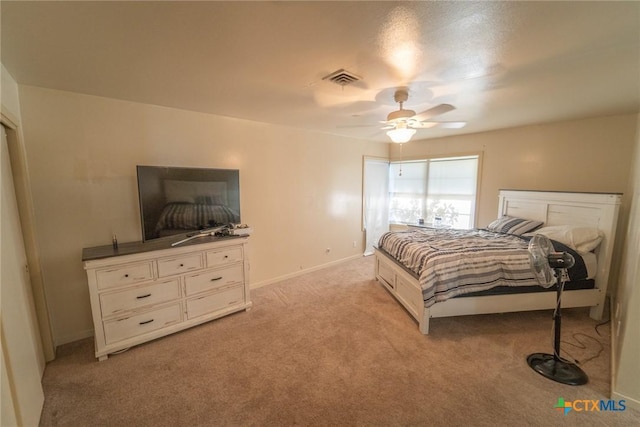 bedroom with ceiling fan and light carpet