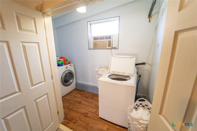 laundry area featuring hardwood / wood-style floors, cooling unit, and separate washer and dryer