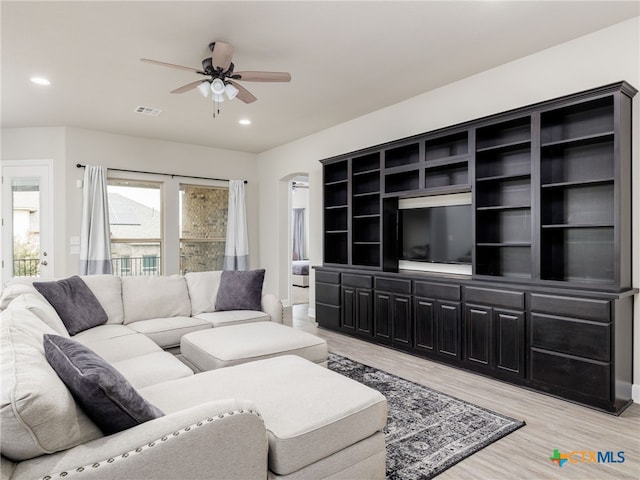 living room featuring light hardwood / wood-style floors and ceiling fan