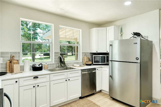 1606 Lone Man Mountain Rd, Wimberley, TX 78676 - kitchen featuring stainless steel appliances, a sink, plenty of natural light, tasteful backsplash, and recessed lighting
