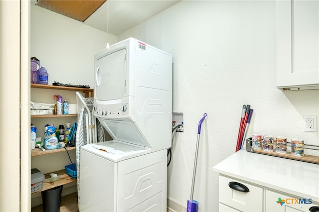 1606 Lone Man Mountain Rd, Wimberley, TX 78676 - washroom with estacked washer and dryer and cabinet space