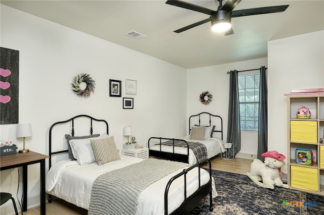 1606 Lone Man Mountain Rd, Wimberley, TX 78676 - bedroom with wood finished floors, baseboards, and ceiling fan