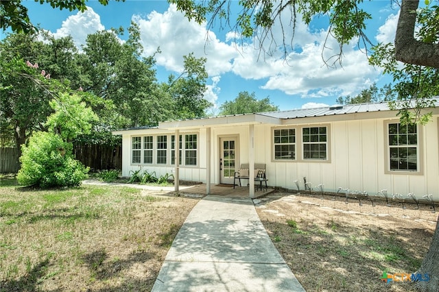 1606 Lone Man Mountain Rd, Wimberley, TX 78676 - ranch-style house with board and batten siding, fence, and metal roof