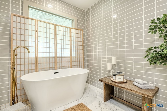 1606 Lone Man Mountain Rd, Wimberley, TX 78676 - bathroom with tile walls, a soaking tub, and marble finish flooring