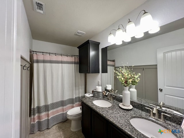 bathroom featuring walk in shower, tile patterned flooring, a textured ceiling, toilet, and vanity