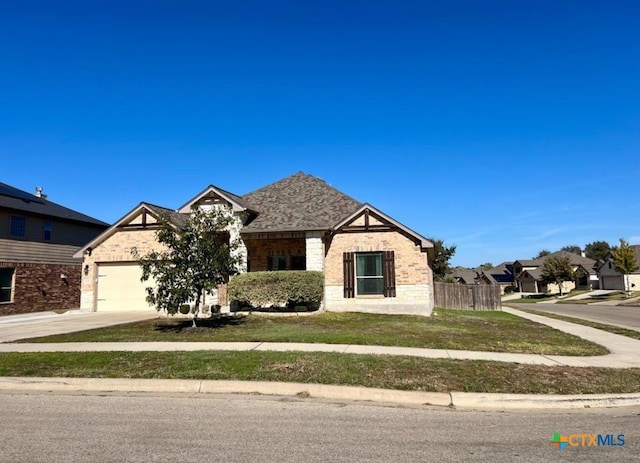 view of front of home featuring a front yard and a garage