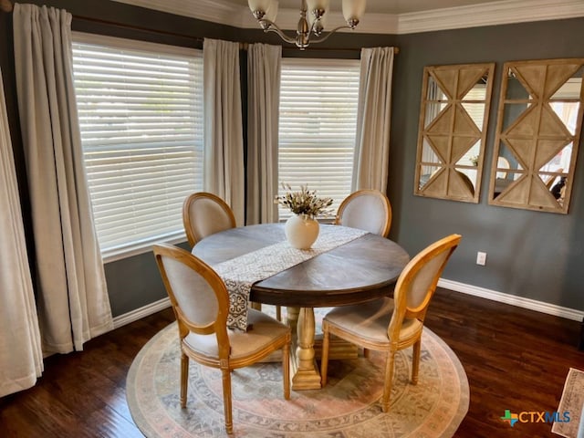 dining area featuring crown molding, dark wood-type flooring, and an inviting chandelier