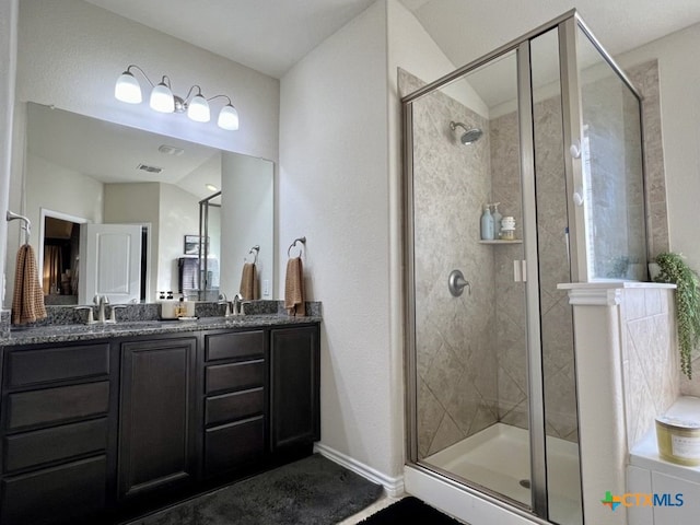 bathroom featuring vanity and a shower with shower door