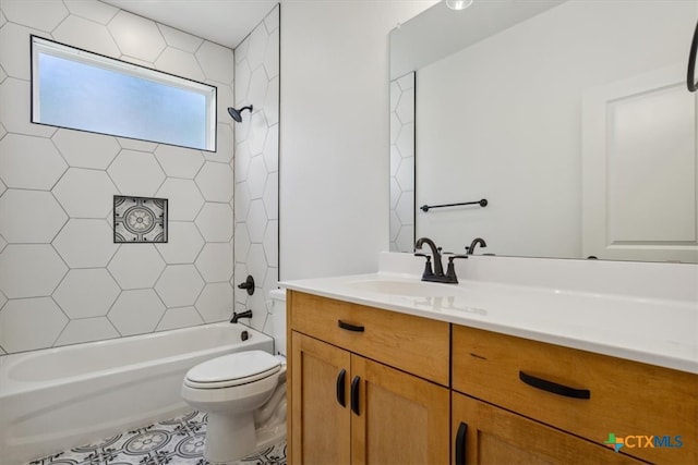 full bathroom featuring vanity, tiled shower / bath, and toilet