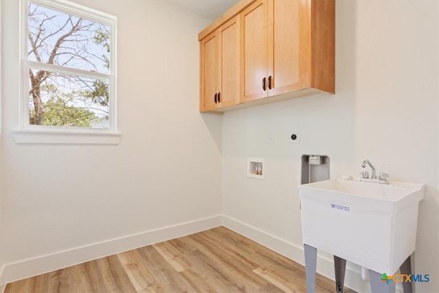 washroom with hookup for an electric dryer, light wood-type flooring, hookup for a washing machine, and cabinets