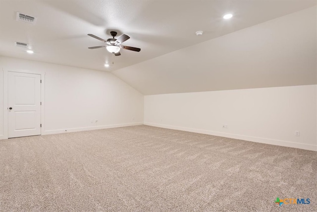 additional living space with carpet flooring, ceiling fan, and vaulted ceiling