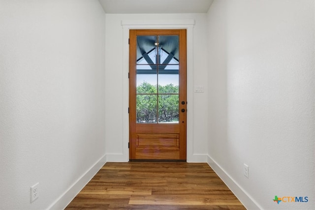 doorway to outside with wood-type flooring