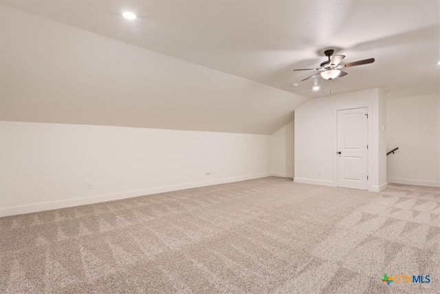 bonus room featuring lofted ceiling, light colored carpet, and ceiling fan