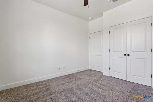 unfurnished bedroom featuring a closet, carpet flooring, and ceiling fan