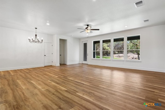 unfurnished living room featuring ceiling fan with notable chandelier and light wood-type flooring