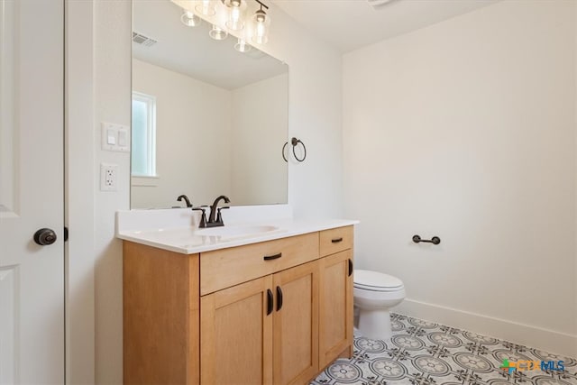 bathroom with vanity, tile patterned floors, and toilet