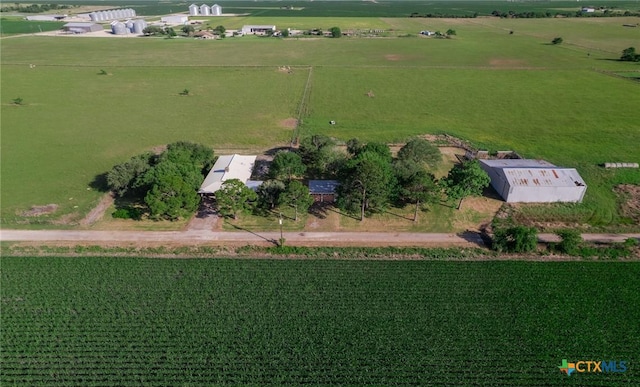 back of property featuring a lawn, brick siding, a carport, and metal roof