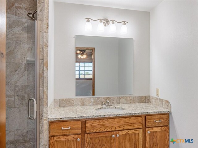 full bathroom with vanity and a stall shower