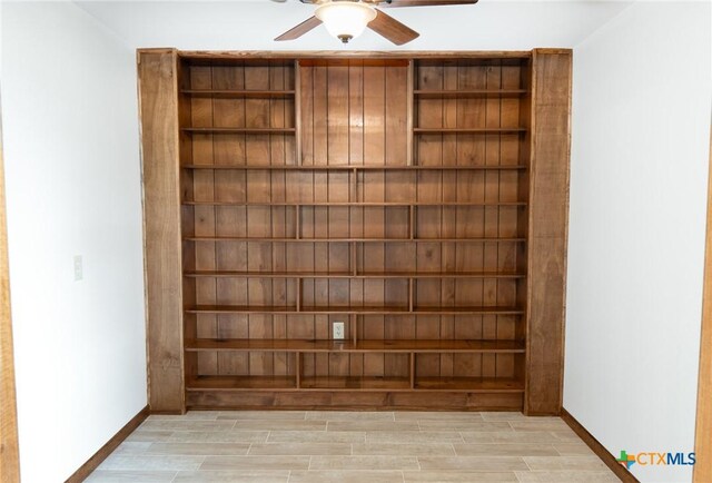 unfurnished living room with visible vents, light wood finished floors, baseboards, and ceiling fan