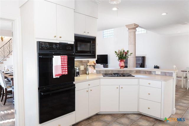 kitchen featuring white cabinets, light countertops, a peninsula, and black appliances