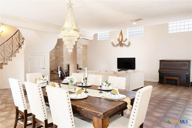 dining area featuring visible vents, baseboards, stairway, ornamental molding, and a chandelier