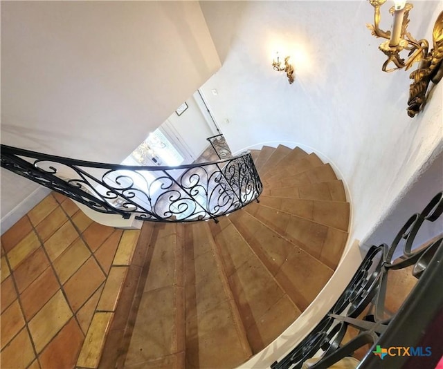 staircase featuring tile patterned floors