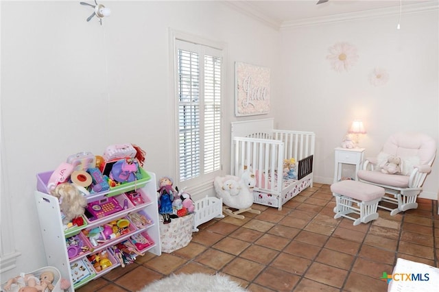 bedroom with a crib, multiple windows, and ornamental molding