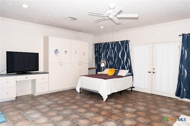 bedroom with crown molding, visible vents, built in study area, ceiling fan, and a textured ceiling