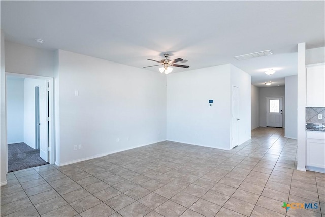 tiled empty room with ceiling fan